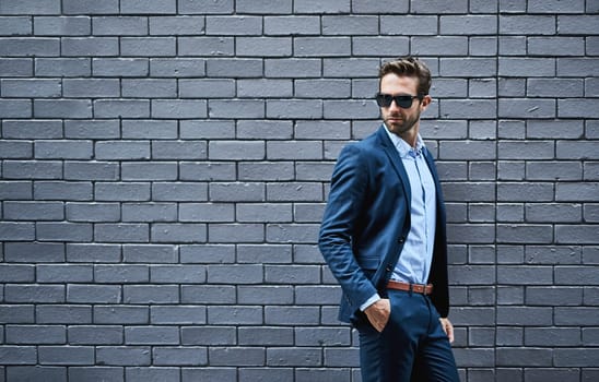 Businessman, sunglasses and confidence in fashion by wall with pride for career, mockup space or professional. Corporate, employee or shades with suit, smart casual or eyewear for creative occupation