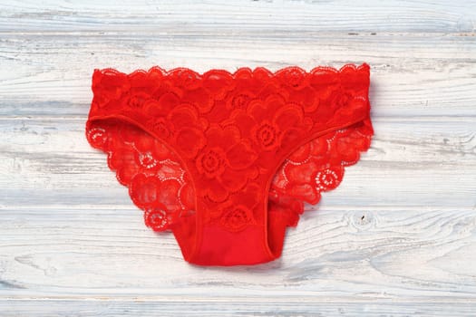 Top view women's underwear panties on a wooden background.