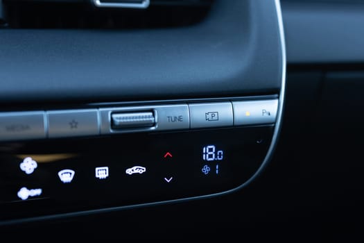 360 degree camera buttons in a new luxury electric vehicle. Electric car control devices. Modern car climate control panel for driver and passenger with shallow depth of field