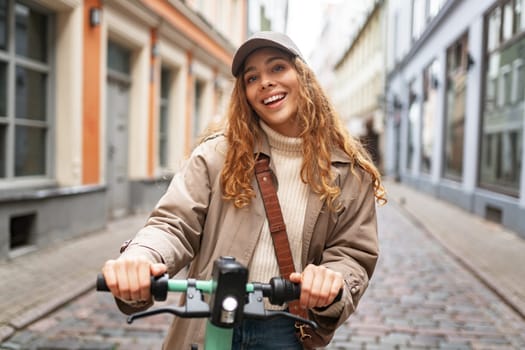 Close up portrait of young woman with electric scooter at the city