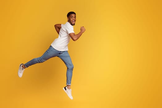 Emotional motivated african-american man running on air