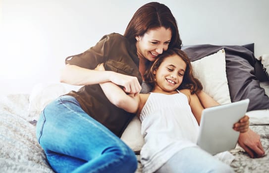 Smile, mother and kid on tablet in bed at home together for game, bonding and family streaming movie. Happy girl, mom and technology in bedroom for learning, education or reading ebook on app online
