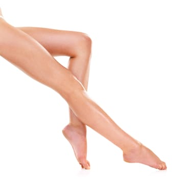 Legs, skin and beauty of feet in studio for shaving, cleaning or waxing for grooming isolated on a white background. Foot, knee and person in epilation, pedicure and natural hair removal treatment.