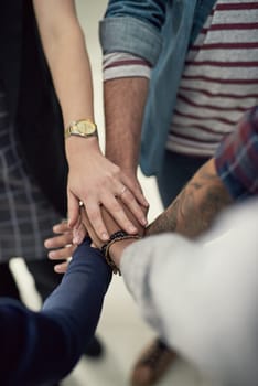 Hands together, teamwork and top view of business people with success, partnership or celebrate goal in creative startup. Above, huddle and group of employees with support for community of designers