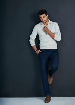Portrait, clothes and man in studio, fashion and serious with minimalism, confidence and proud of outfit. Dark background, stylish and person in jeans, denim and professional for business and job.