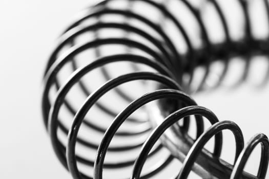 Metal spring coiled, black and white macro shot
