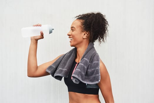 Black woman, athlete and drinking water in studio, training and hydration after workout on white background. Female person, profile and liquid for recovery after exercise, fitness and mockup space