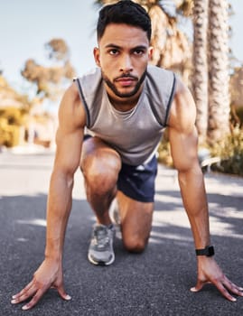 Man, runner and start line for sport, fitness and exercise in race or competition on road or street. Serious, male athlete, and ready to start running for marathon training and muscle development