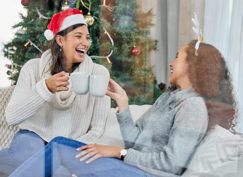 Happy woman, friends and Christmas with coffee on sofa at home for celebration or festive season. Female person or people laughing with smile for conversation, funny joke or drink on December holiday.
