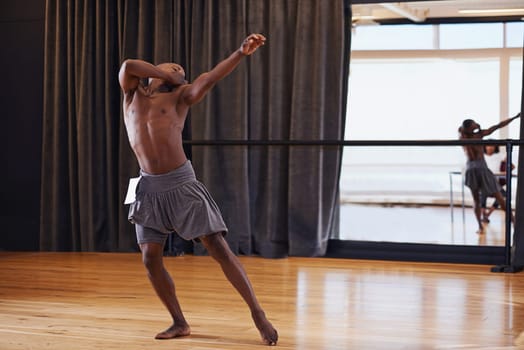 Studio, talent and male dancer in audition, dancing and sport of art, performance and flexible with health. Competition, grace and energy of black man, stage and body with balance, ballet and show