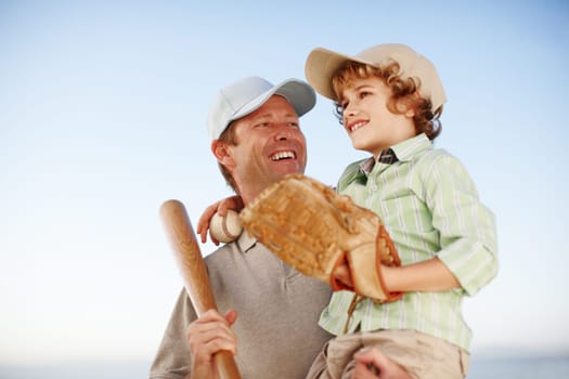 Father, boy and happy for baseball, outdoor and game with hug for love, bonding and teaching. Family, papa and child with bat, glove and softball for sports, learning and embrace for fitness at field.