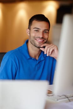 Businessman, desk and smile in portrait with computer in office with confidence for graphic designer. Male person, table and happy with computer for technology with creative, internet and web design