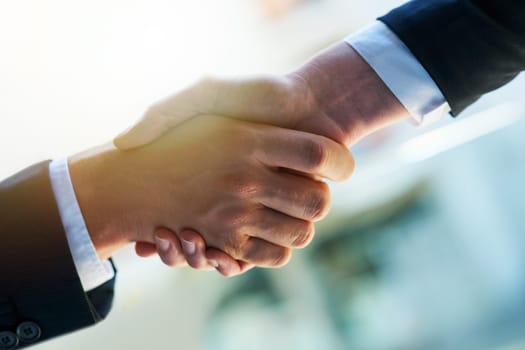 Business people, handshake and partnership with b2b for meeting, collaboration or greeting at office. Closeup of employees shaking hands for introduction, agreement or teamwork together at workplace.