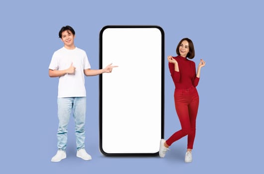 Two people presenting a giant smartphone screen