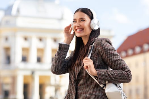 Young woman with headphones enjoying music, going to university