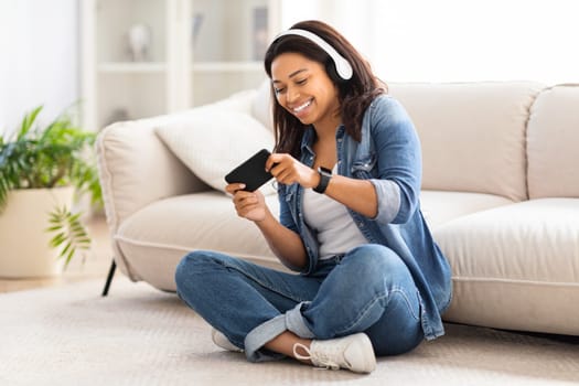 Woman Sitting on Floor Playing With Smartphone