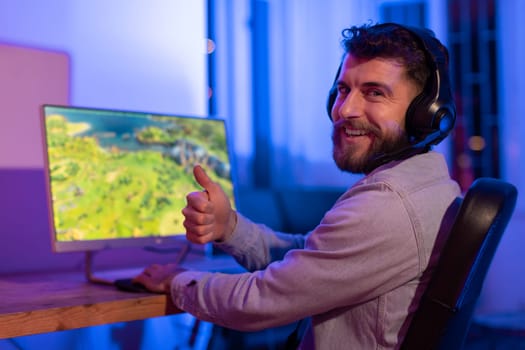 Gamer man enjoys leisure time at gaming setup