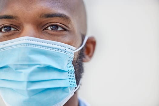 Doctor, black man or face mask for safety, protection and coronavirus compliance on grey background. Closeup, studio and African person with medical regulations for virus, pandemic and covid policy