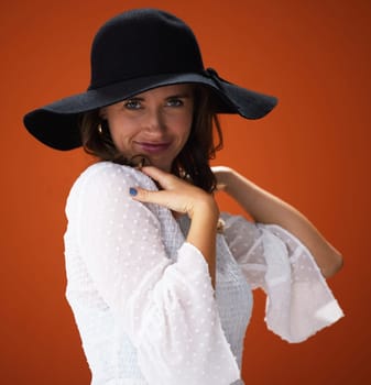 Woman, studio and hat with portrait for fashion with trendy, cool and summer outfit for vacation style inspiration. Designer, brown background and trends with glamour for clothing with pride