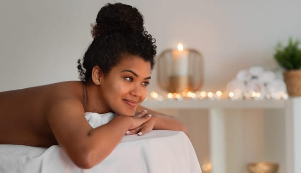 Relaxed Black lady at a soothing spa setting