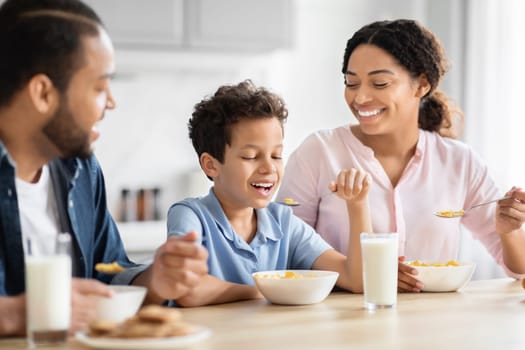 Family eating breakfast together in kitchen at home