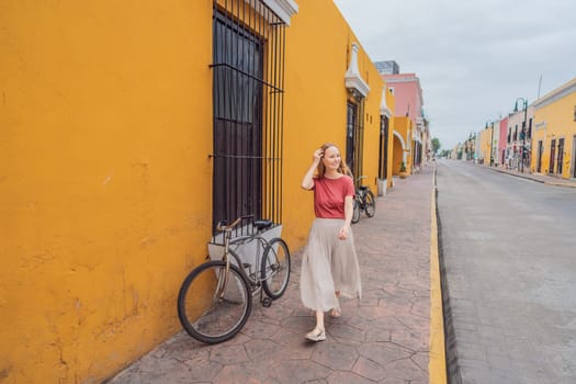 Woman tourist explores the vibrant streets of Valladolid, Mexico, immersing herself in the rich culture and colorful architecture of this charming colonial town