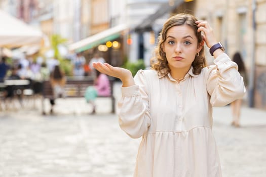 Confused woman feeling embarrassed about ambiguous question, having doubts, no idea in city street