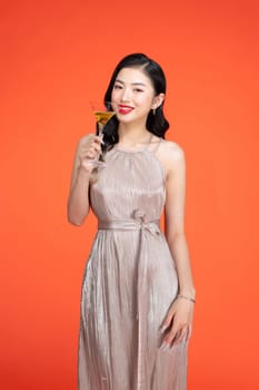 Attractive young female holding drink, wine or alcohol in celebration for special occasion