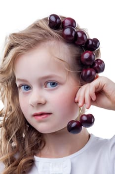 Shot of blue-eyed girl with cherries on her head