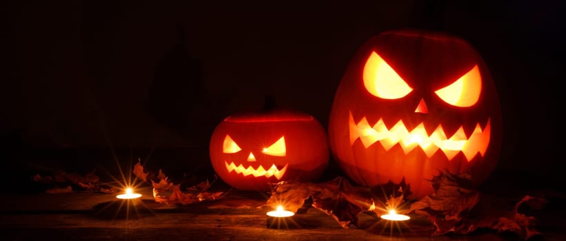 Three Halloween Pumpkins and candles