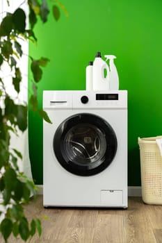 Detergent bottle on washing machine in a laundry room