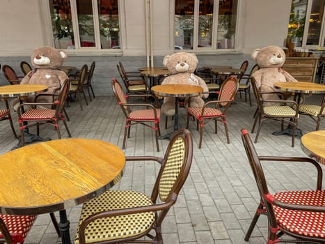 soft toys in the restaurant at the table of large teddy bears