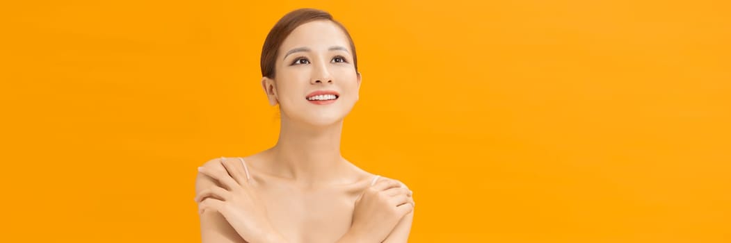 Young lovely woman is touching her shoulder. Web banner