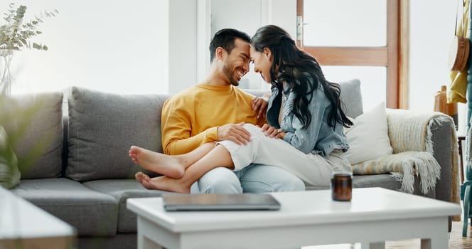 Couple, relax and romance on sofa, talk and happy in home living room, bonding and funny joke. Man, woman and smile together with intimate chat, care and comic conversation on lounge couch in house.
