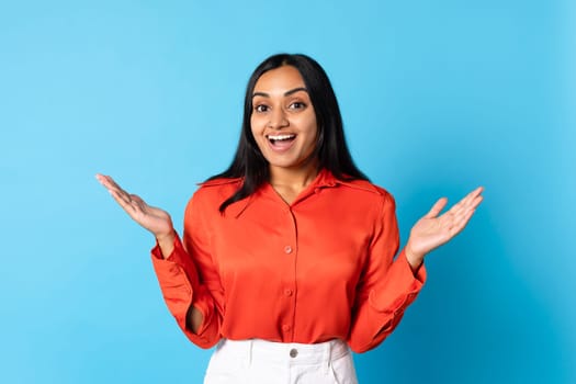 Indian Woman Shouting With Joy And Excitement Over Blue Background