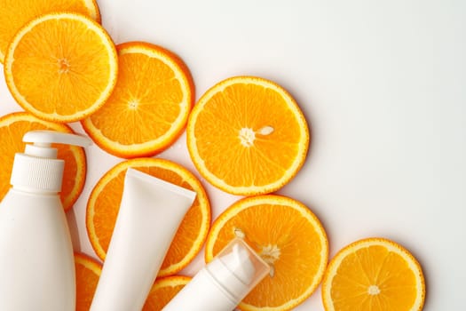 Skincare cosmetic containers on stacked orange slices