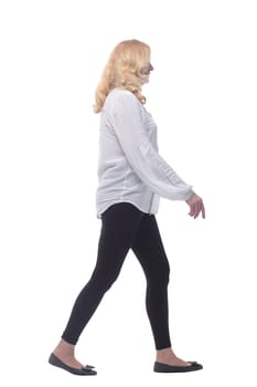 side view. woman in comfortable clothing striding forward .