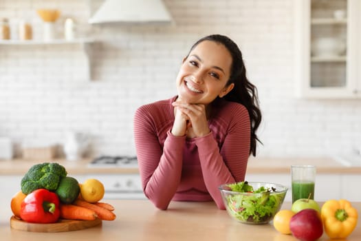 Nutrition Specialist Lady Posing At Kitchen Table With Vegetables Indoor