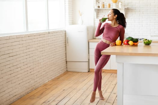 Full Length Shot Of Fitness Woman Enjoying Smoothie At Kitchen