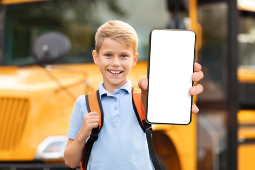 Great App. Smiling Preteen Schoolboy Showing Big Blank Smartphone With White Screen