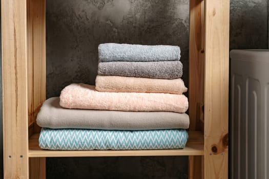 Clean folded towels on shelf in a bathroom