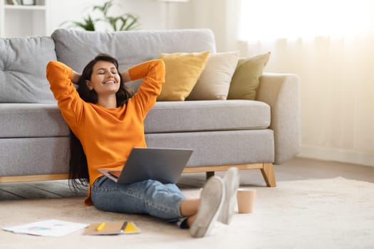 Delighted young indian woman independent contractor resting at home