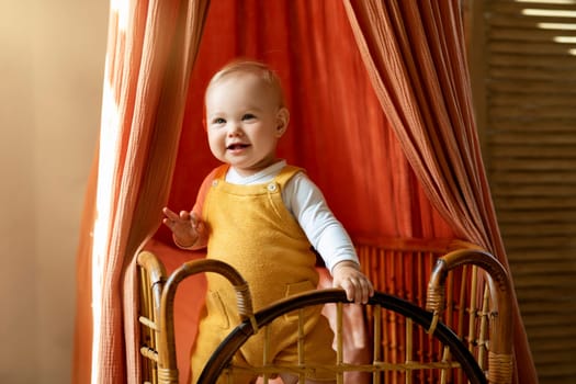 Closeup Shot Of Adorable Infant Baby Standing In His Wooden Retro Crib