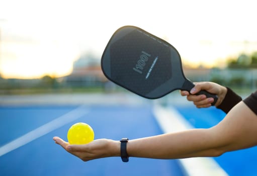 Pickleball tennis racket. Background with copy space. Sport court and ball.
