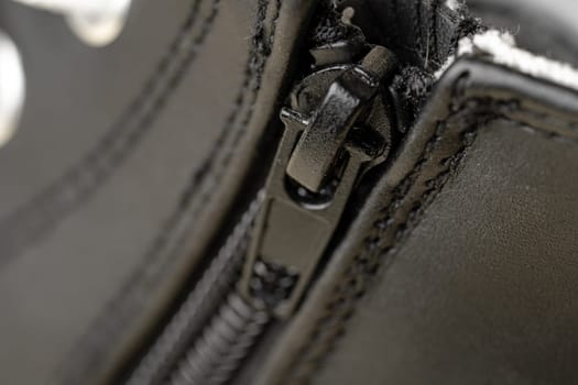 Metal zipper on leather shoe close up