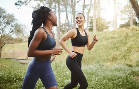 Happy woman, friends and running in forest for workout, training or outdoor cardio exercise together. Active female person, athlete or runners smile for sports run, sprint or race in nature fitness