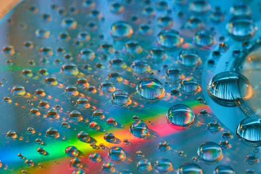 Gorgeous blue background with bubbles and streak of rainbow lighting in abstract asset