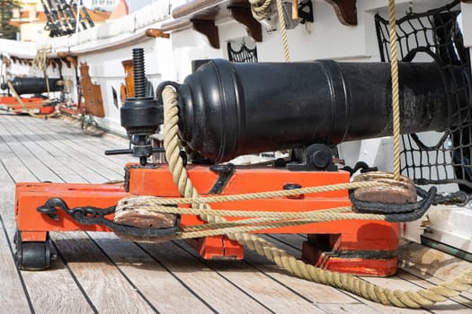 Historirical old cannon on battle sailing vessel