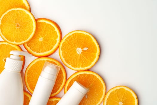 Skincare cosmetic containers on stacked orange slices