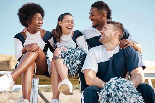 Cheerleader, sports and people laugh on bench for performance, dance and motivation for game. Teamwork, dancer and people laugh in costume for support in match, competition and field event outdoors